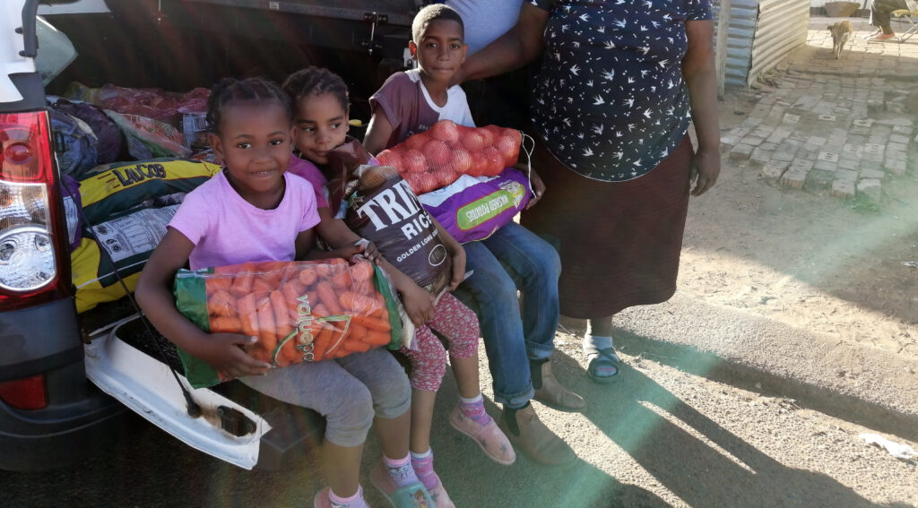 Feeding scheme kids in bakkie